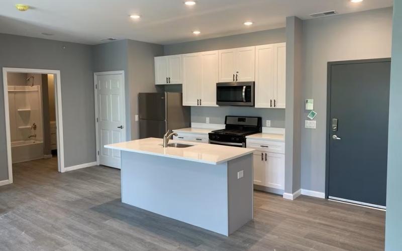 a kitchen with white cabinets and a kitchen island
